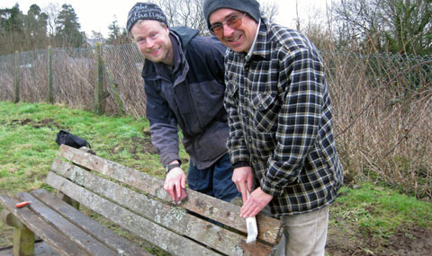 Volunteers refurbishing a bench in Peterston Super Ely